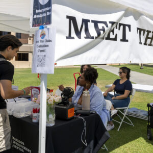 Employees from the Matador Involvement Center checking in students' clubs at a booth.