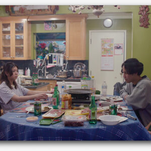 Members of the group "Hooligans" sitting around a dinner table.
