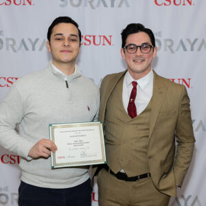 CSUN student Gustavo Garcia, holds a certificate while standing with his supervisor, Cameron O'Hanlon, at The Soraya.