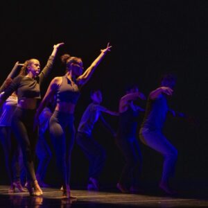 Students dancing with their arms raised.