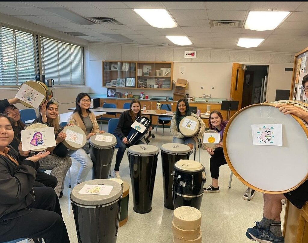 A group of students with a variety of drums