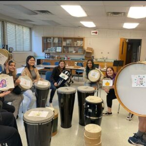 A group of students with a variety of drums