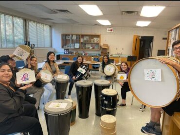 A group of students with a variety of drums