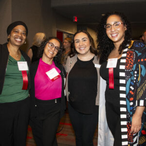 Four women smile for a photo at the 58th Annual Staff Service Awards.