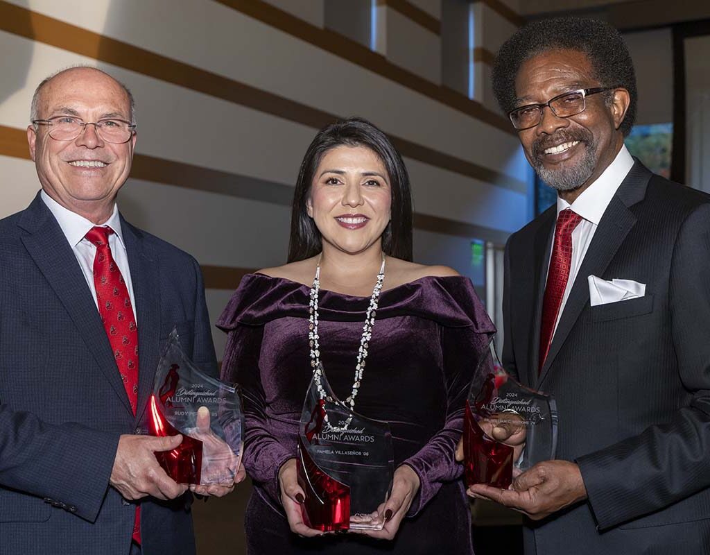 CSUN's 2024 Distinguished Alumni Awards honorees pose for a photo together: From left, they are Rudy Pereira ’85, Pamela Villaseñor ’06 and William Watkins ’74.