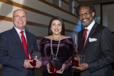 CSUN's 2024 Distinguished Alumni Awards honorees pose for a photo together: From left, they are Rudy Pereira ’85, Pamela Villaseñor ’06 and William Watkins ’74.