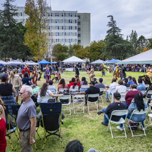Members of the crowd enjoy the 2024 CSUN Powwow from seats on the Sierra Quad lawn.