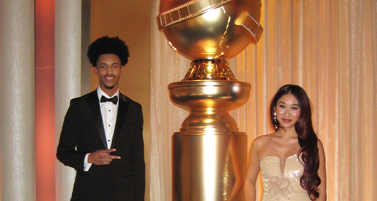 CSUN film students Albert Rutledge and Nikolet Ocampo stand next to a life-sized Golden Globe Award, backstage right before the show.