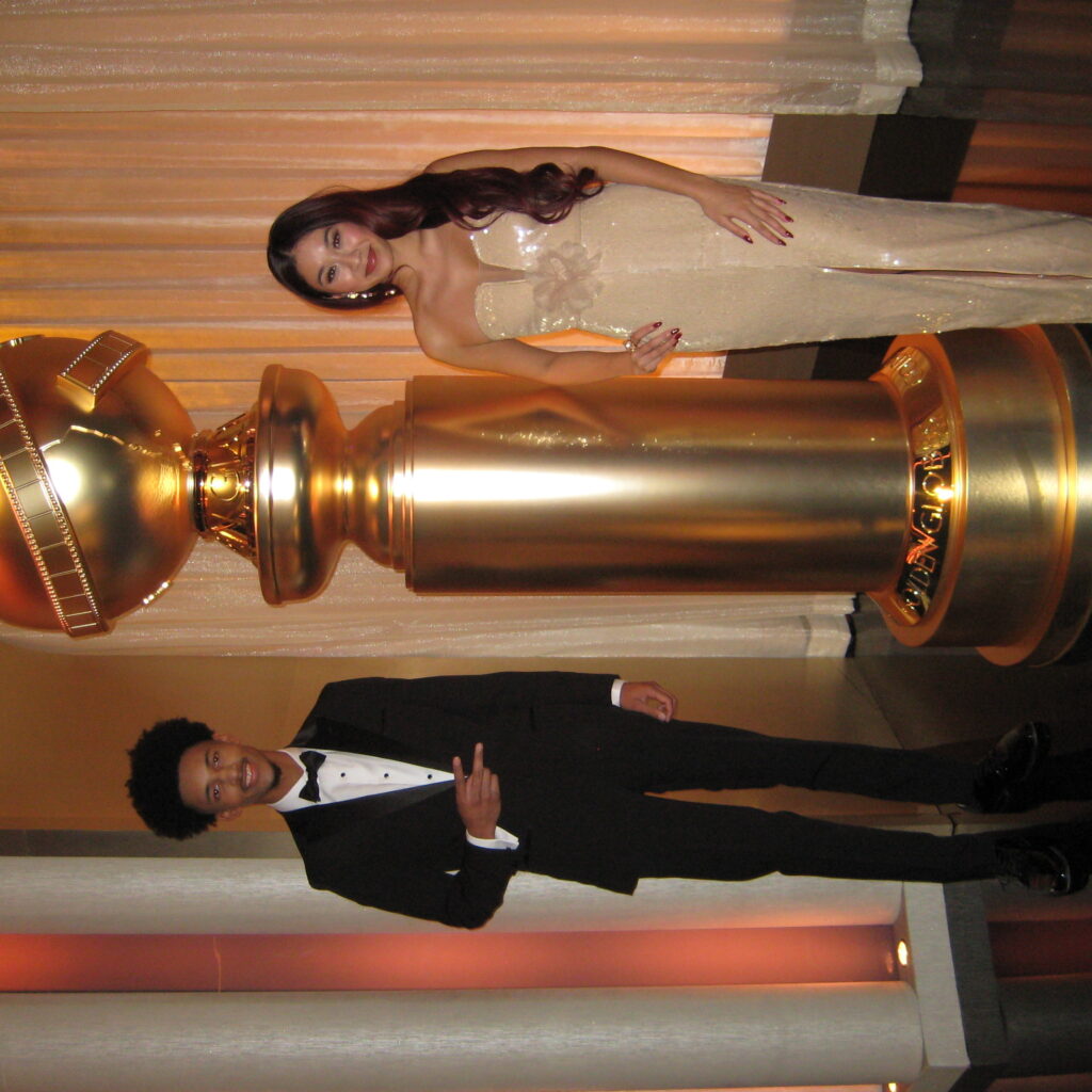 CSUN film students Albert Rutledge and Nikolet Ocampo stand next to a life-sized Golden Globe Award, backstage right before the show.