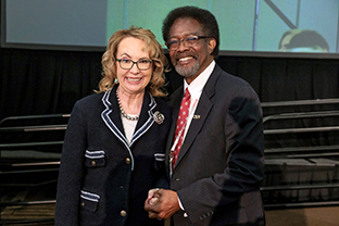 Former Congresswoman Gabby Giffords poses for a photo with William Watkins, vice president for Student Affairs and dean of students