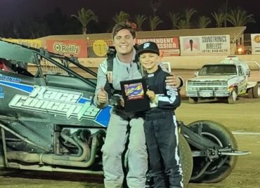 CSUN alumni Cole Wakim celebrates on the track with a fan. (Photo courtesy of Cole Wakim)