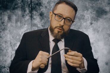 "Meathook" director, Jermey Ashley poses with a meathook for a profile shot.