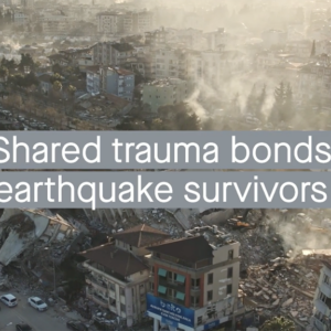 The words 'Shares trauma bonds earthquake survivors' superimposed over earthquake rubble.