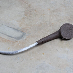 A ceramic showerhead layed down on concrete ground.