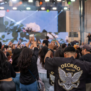 A crowd of people dance in front of a stage.