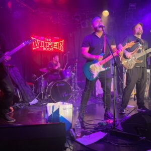 The Band, CANO, performing a song on stage at a venue called The Viper Room.