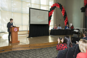 The Bull Ring stage with Steven Van Alen at podium and judges' panel.