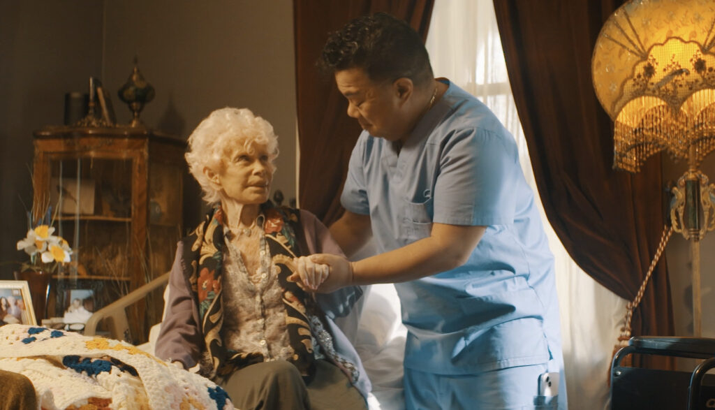 A caregiver helping an older woman.