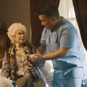 A caregiver helping an older woman.