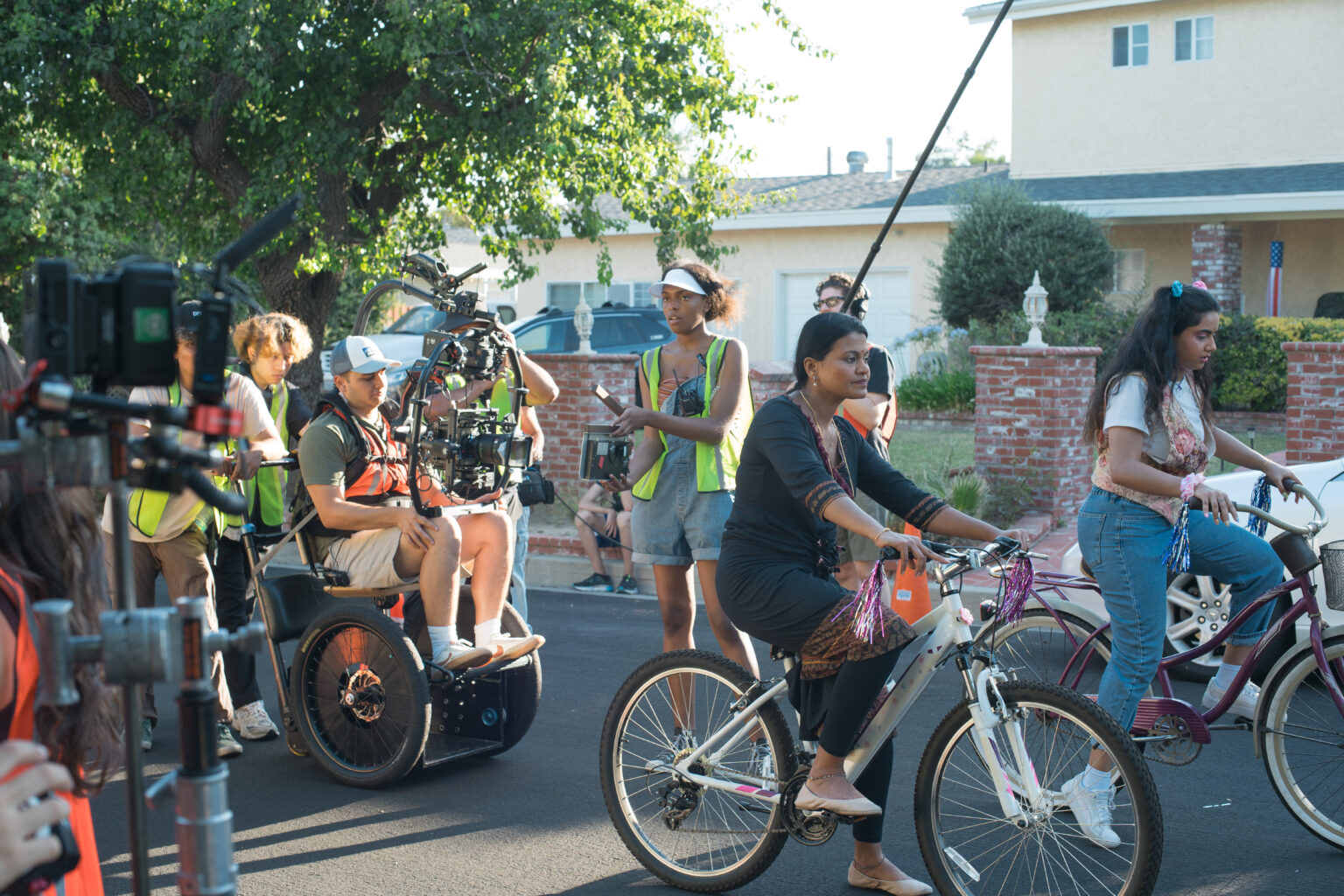 filming a scene for Moksha. 2 girls riding a bike.