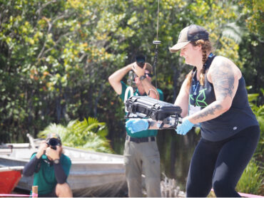 Denita Weeks retrieves water samples from a hovering drone outside the Amazon rain forest.