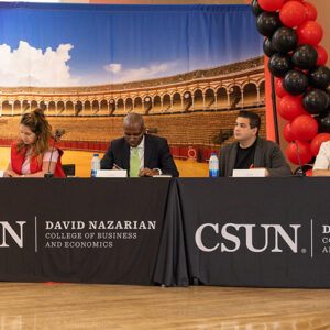 Four judges sit in a row, listening to product pitches.