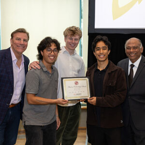 Three students in center, pose with their certificate, with Jon Georgio on the far left and Chandra Subramaniam on the far right.