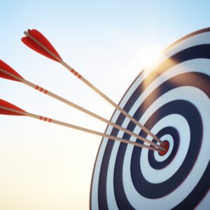 An archery target with three arrows within the bullseye range.