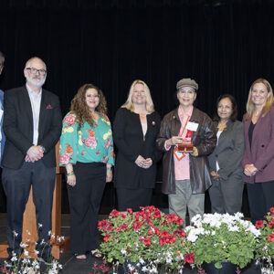 Hai-Ling Tang poses on stage with CSUN President Erika D. Beck and cabinet members.