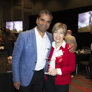 Ranjit A. Philip and Helen Heinrich pose for a photo with Helen holding award plaque.