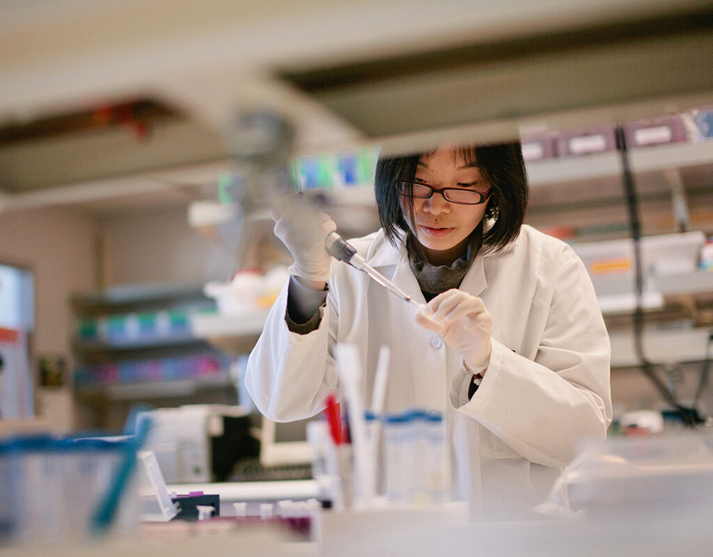 Scientist Pipetting at a Biomedical Laboratory