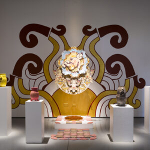 A baby, four ceramic vessels and a painted wall form the centerpieces of an art exhibit.
