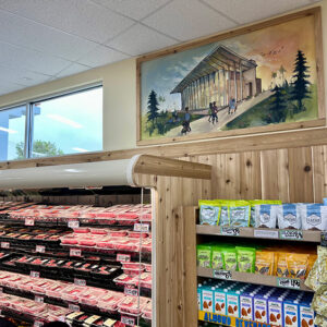 A mural of CSUN's library is displayed above a cold case in Trader Joe's, Northridge location.