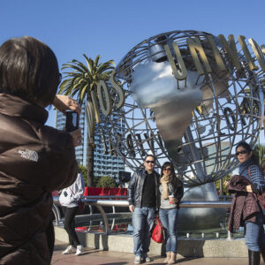 Chinese tourists take pictures at the Globe Fountain in Universal Studios Hollywood. .(Photo by Ringo Chiu)