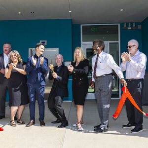 CSUN President Erika D. Beck and university administrators stand in a line and applaud.