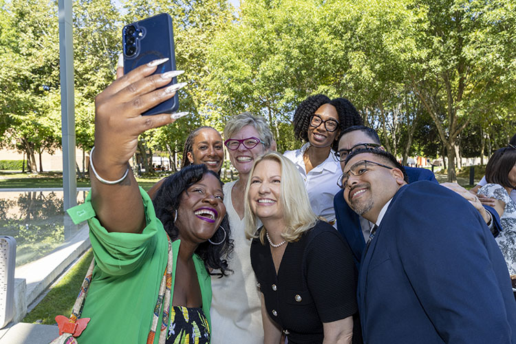 CSUN President Erika D. Beck and 5 colleagues smile for a selfie.