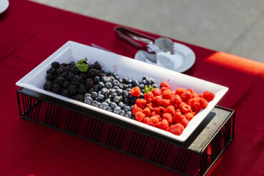 Photo of white platter that holds raspberries and blueberries.