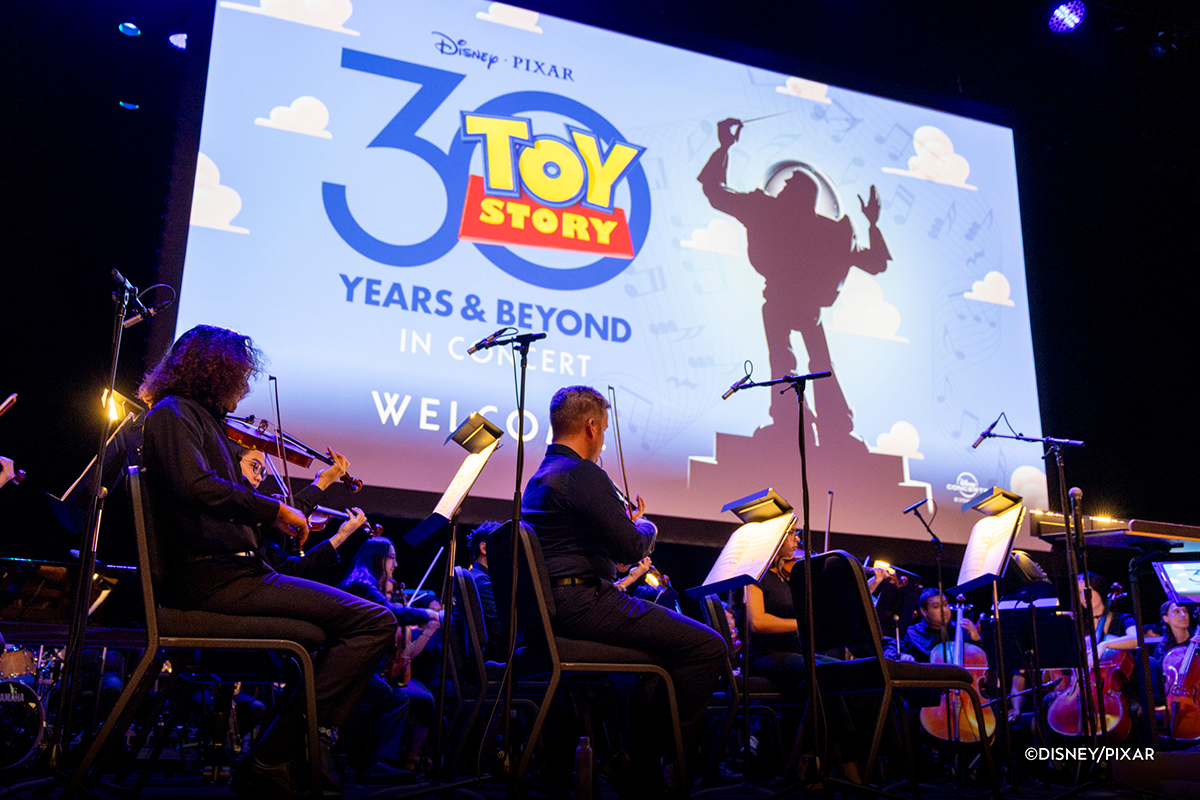 The CSUN Symphony orchestra performs in front of "Toy Story" 30th anniversary title screen.