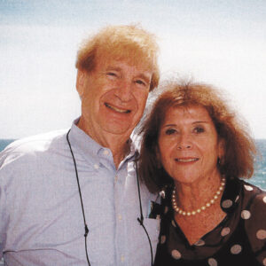 Shepard and Ronni Goodman stand together in front of an ocean.