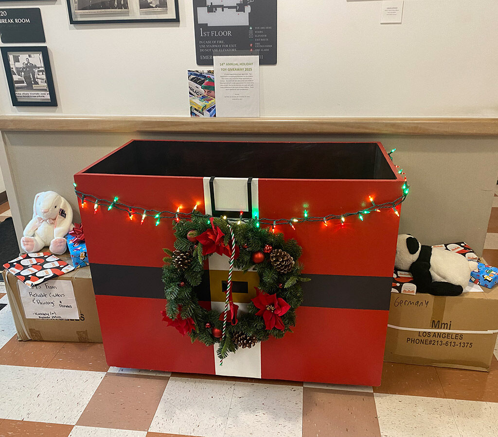 A red toy box decorated with a string of lights.