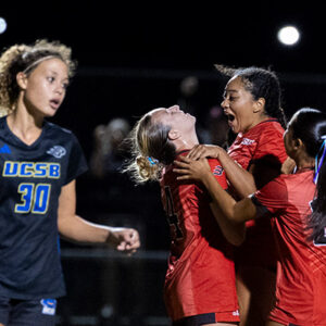 Soccer players hug each other on the field