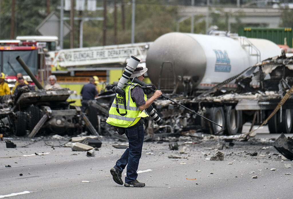AP photographer Reed Saxon wearing PPAGLA Media Safety Vest in the the scene of a multi-vehicle crash on  5 Freeway near Griffith Park, Tuesday, April. 25, 2017, in Los Angeles. (Photo by Ringo Chiu)

Usage Notes: This content is intended for editorial use only. For other uses, additional clearances may be required.