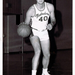 Vintage picture of CSUN basketball great Mark Cooley dribbling a basketball.