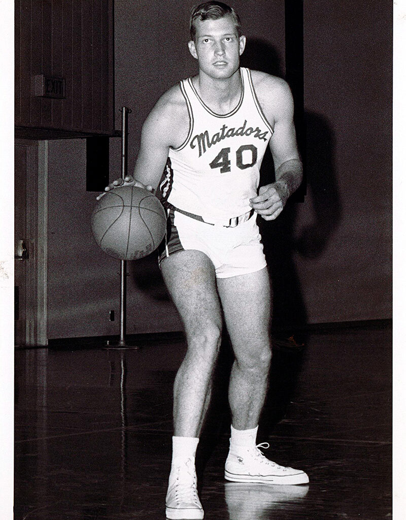 Vintage picture of CSUN basketball great Mark Cooley dribbling a basketball. 
