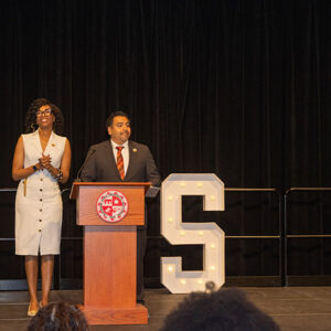 Marquita Gammage, professor of Africana Studies and director of the Ethnic Studies Center for Research, Activism and Community Engagement, and Freddie Sanchez, associate vice president for Student Affairs, Equity and Inclusion, stand at a wooden podium in front of large, white letters that spell out BSI: Black Serving Institution.