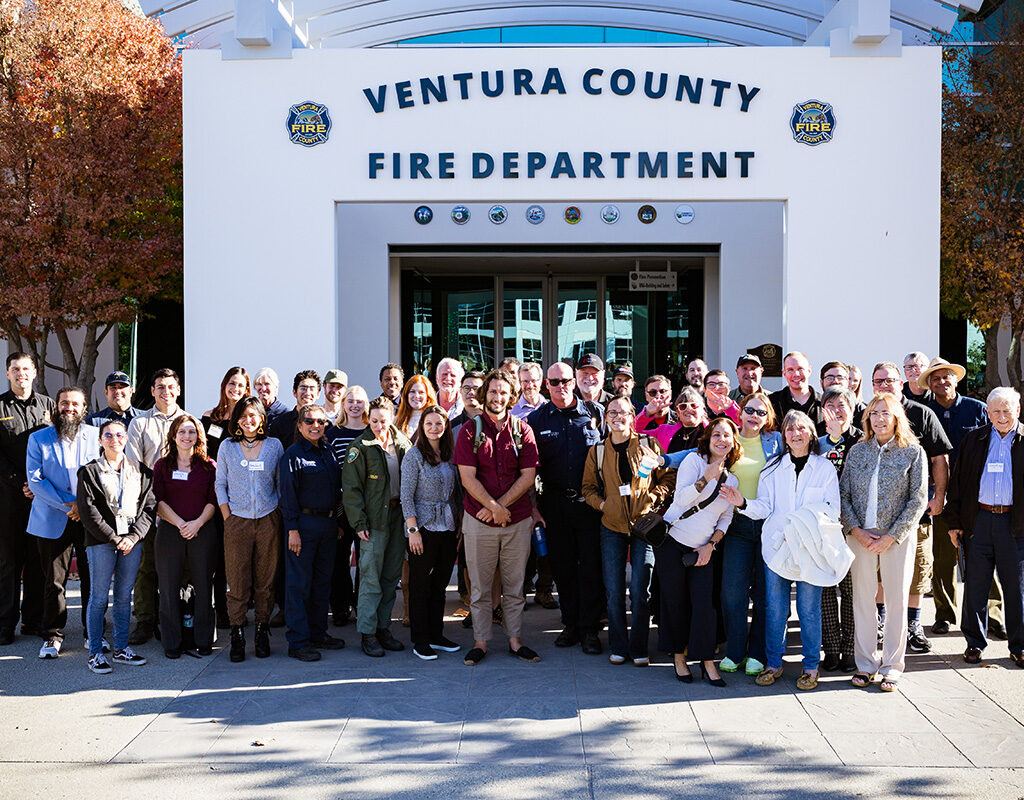 Large group of people gathered for a photo with the Ventura Cunty Fire Department building in the background.