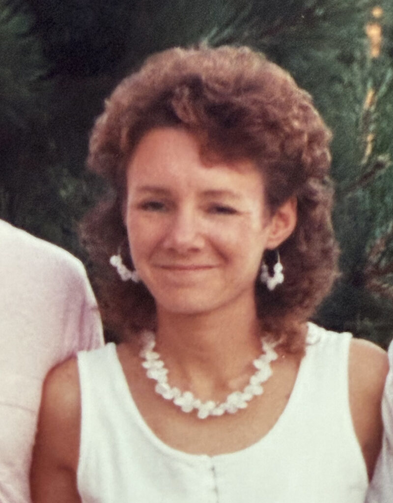 Portrait of Peggy Searight with white top and matching earrings and necklace.