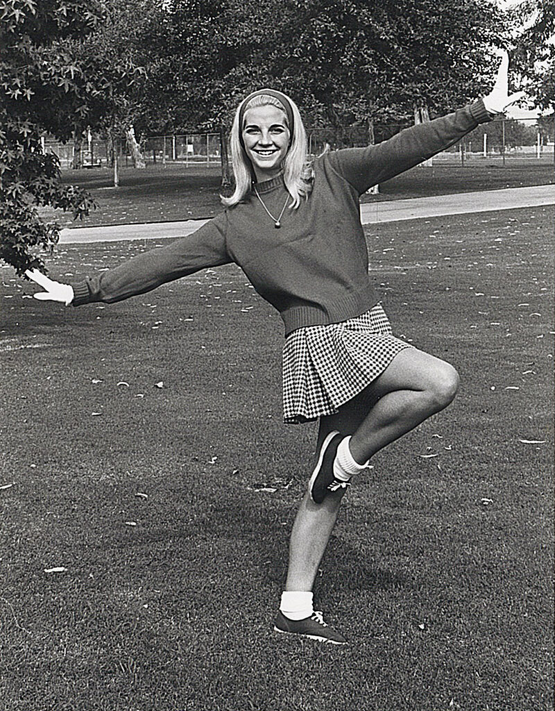 Vintage photo of CSUN alum Diana Cooley in long sleeves and a skirt. 