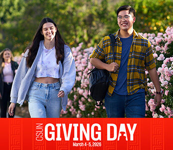 Two students walk together by rose bushes. Red banner across the bottom of the photo says CSUN Giving Day, March 4-5, 2026.