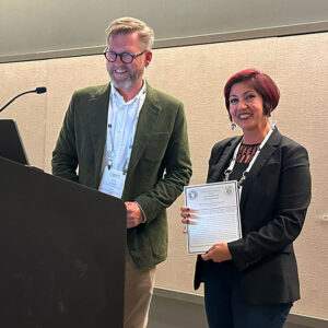 CSUN structural geologist Elena Miranda accepting the Geological Society of America’s Structural Geology and Tectonics Division for its highest publication honor, the Structural Geology and Tectonics Division Outstanding Publication Award, from Eric Cowgill of UC Davis. Photo courtesy of Elena Miranda.